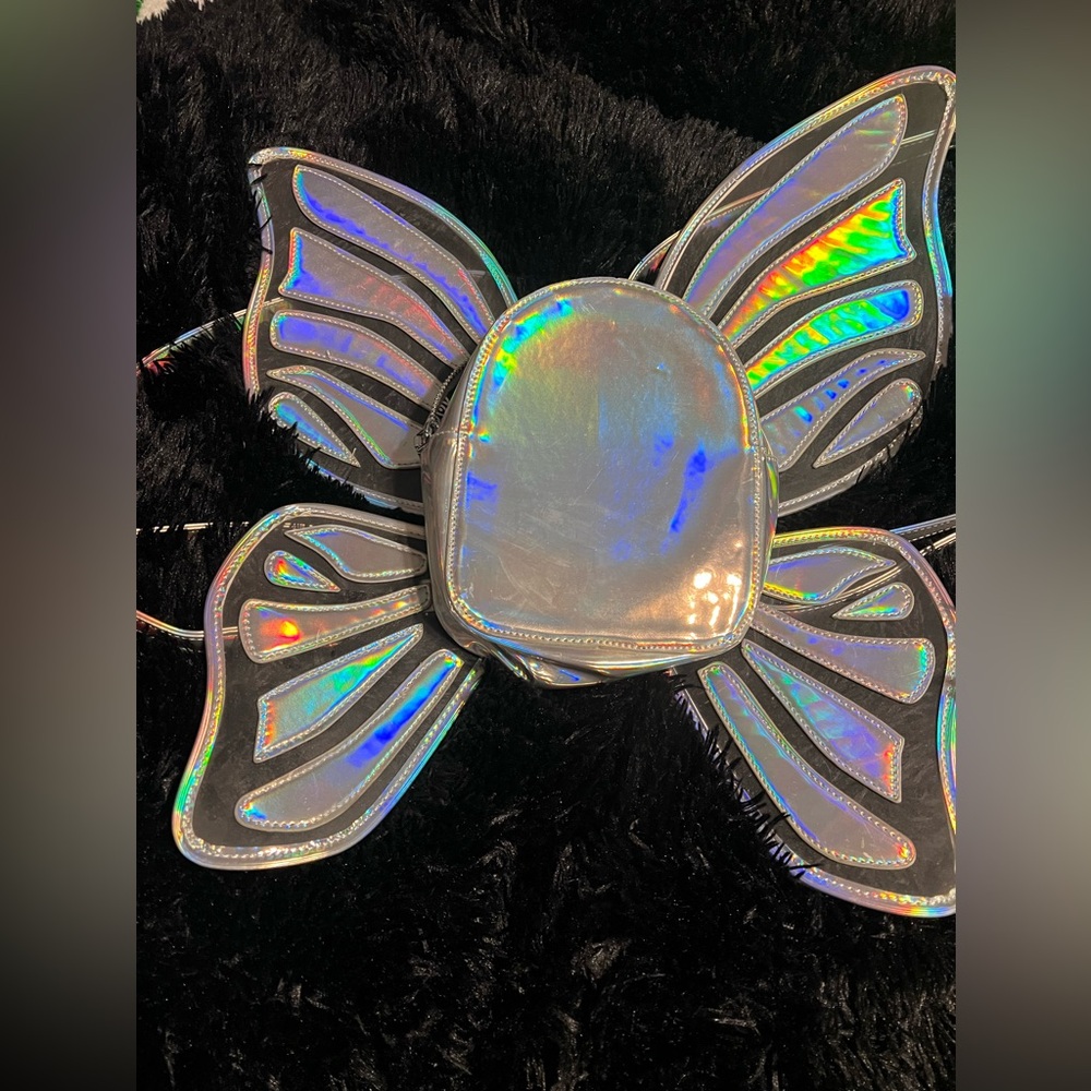 Never been used Mini holographic backpack with butterfly wings.